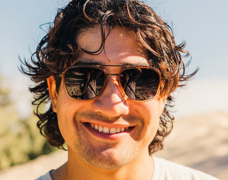 guy smiling wearing sunski estero sunglasses