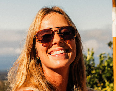 girl smiling wearing sunski estero sunglasses