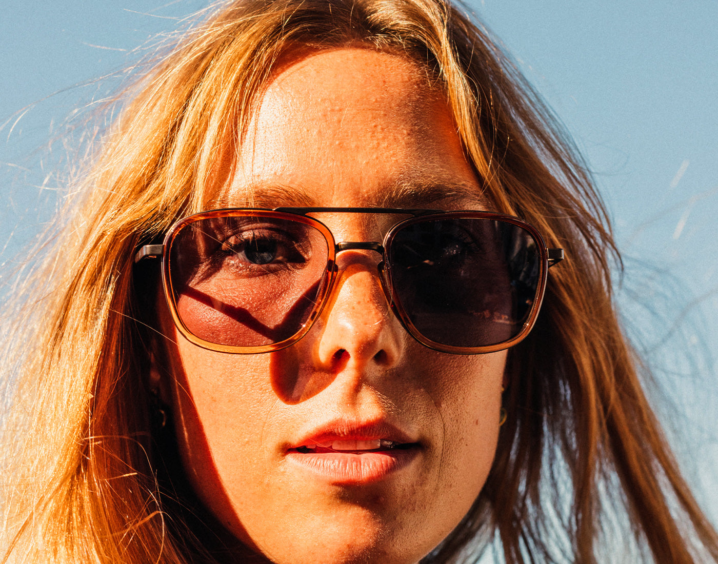 close up of girl wearing sunski estero sunglasses