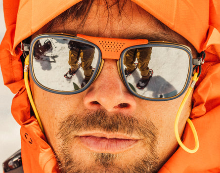 close up of man with hood on wearing sunski ferrata sunglasses