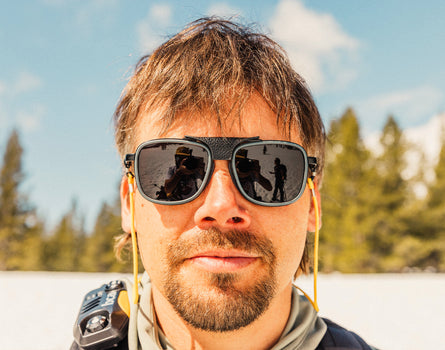 guy looking at the camera with a straight face wearing sunski ferrata sunglasses