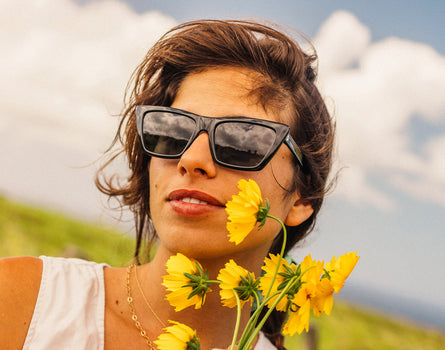 girl holding flowers wearing sunski fiorella sunglasses