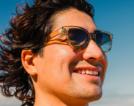 profile of a man smiling wearing sunski miho sunglasses