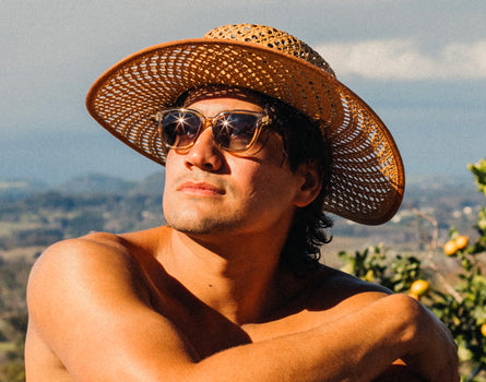 guy in a straw hat wearing sunski miho sunglasses