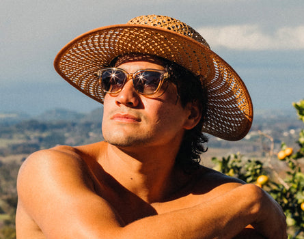 guy in a straw hat wearing sunski miho sunglasses