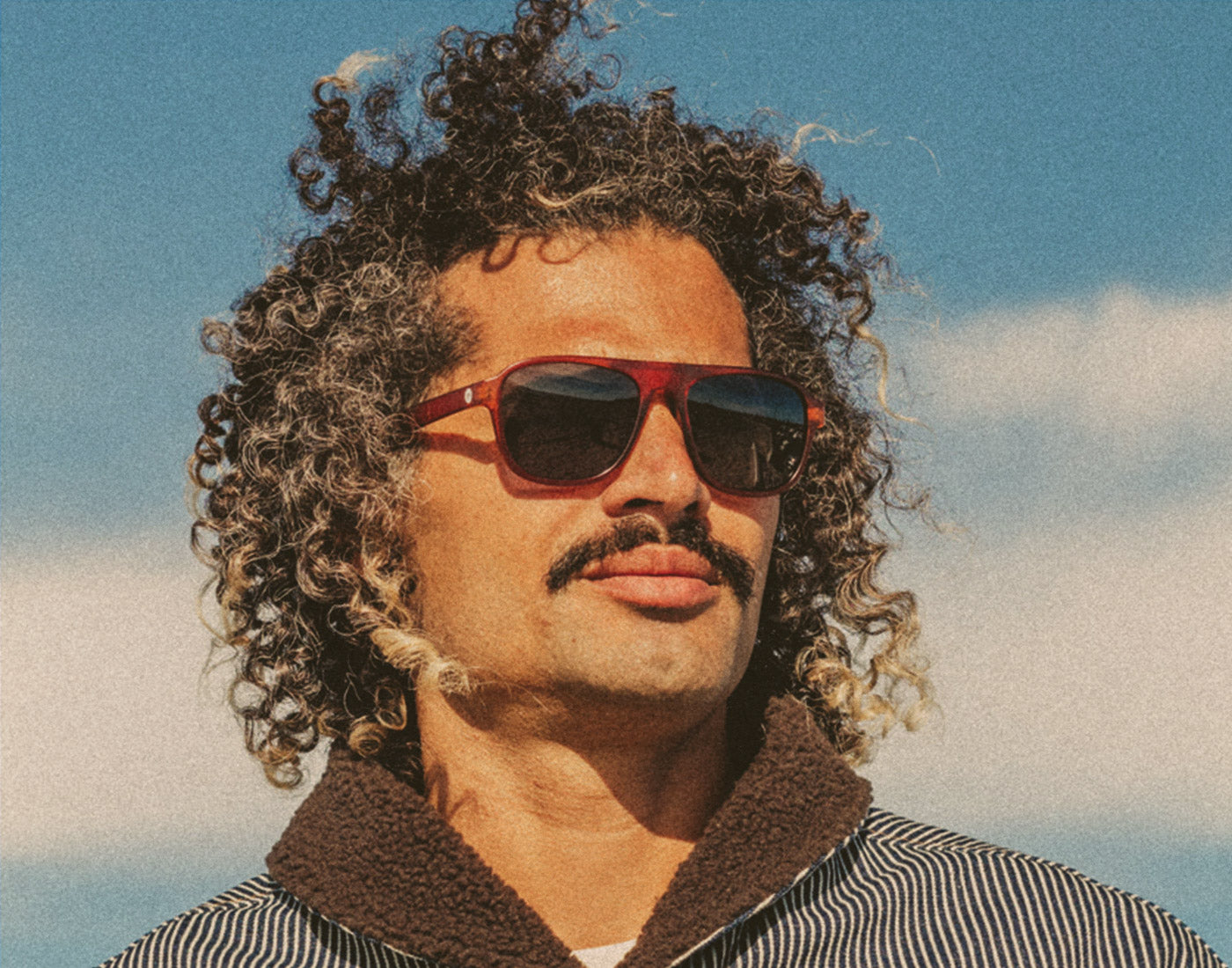 man looking in the distance wearing sunski shoreline sunglasses