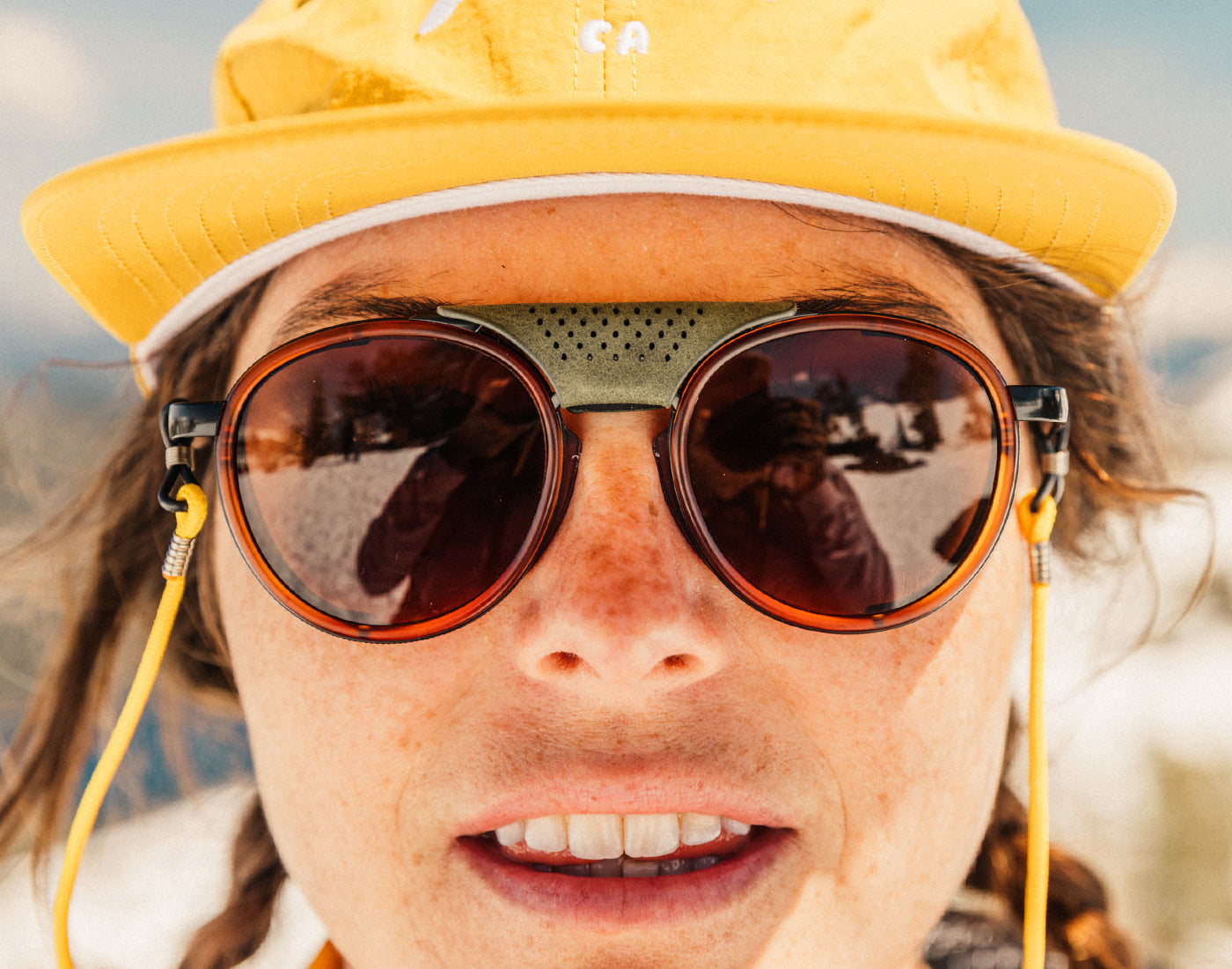 close of girl looking serious wearing sunski strada sunglasses