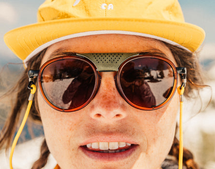 close of girl looking serious wearing sunski strada sunglasses