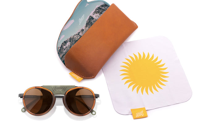 sunski strada rust amber laydown with sunglasses and case