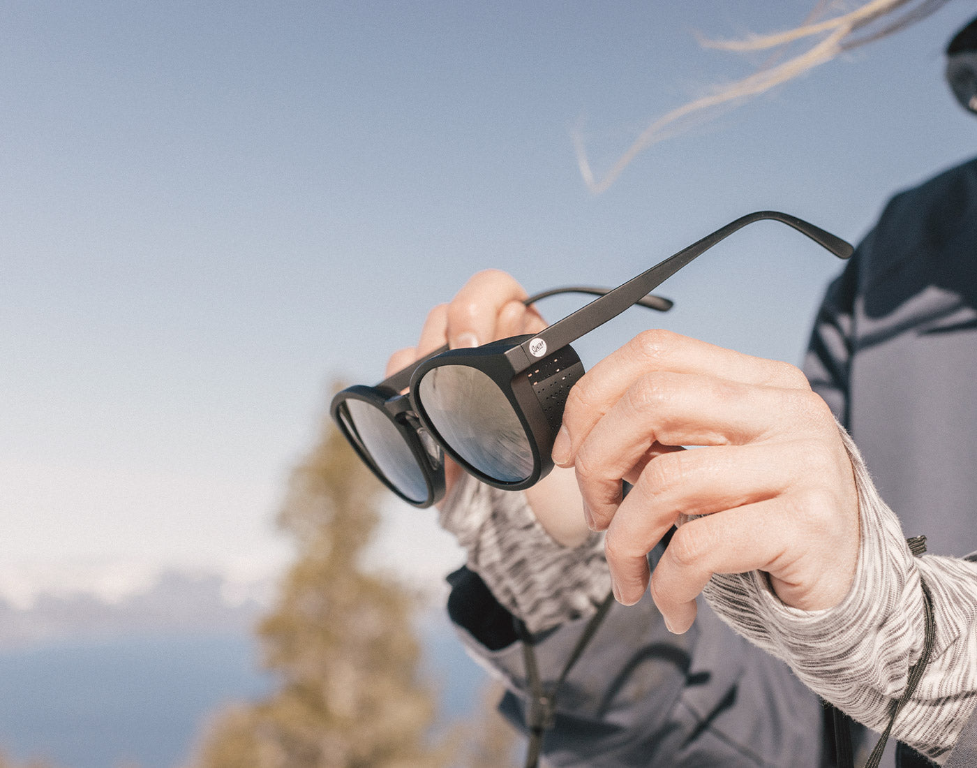 hands messing with sunski tera sunglasses sun shields