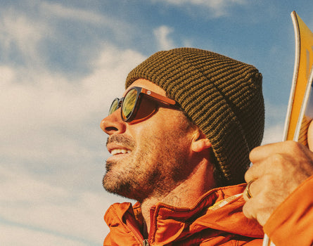 profile of man wearing a beanie and sunski tera sunglasses