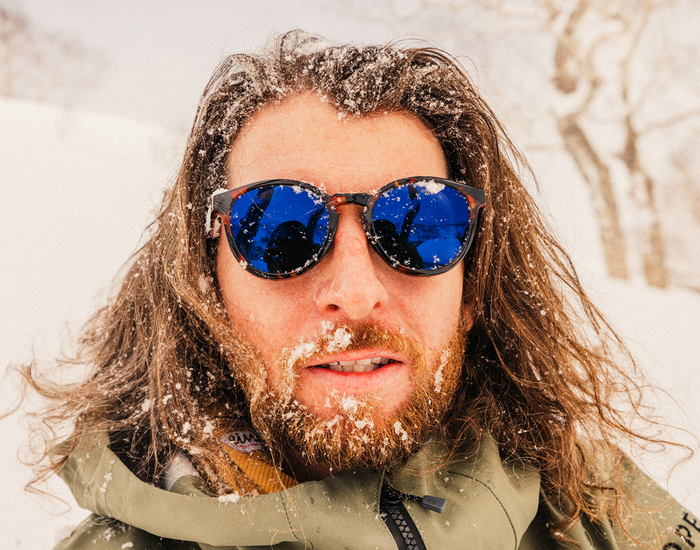 guy with snow on his face wering sunski tera sunglasses