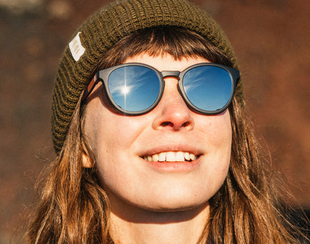 girl in beanie wearing sunski tera sunglasses