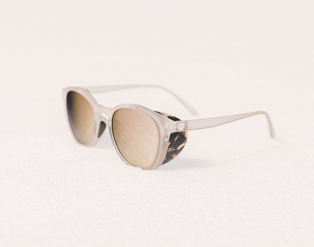 sunski tera sunglasses resting on snow