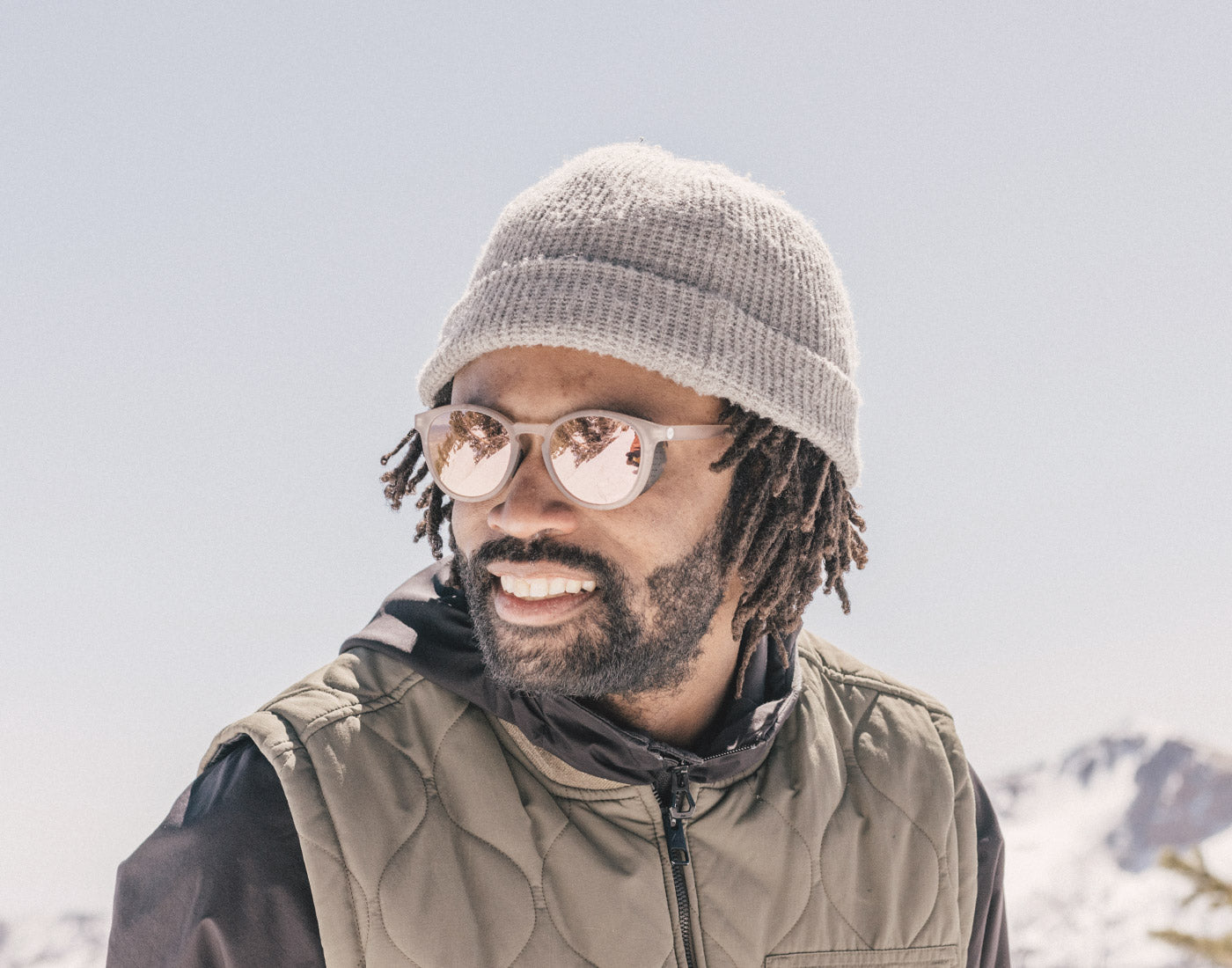 guy in a beanie wearing sunski tera sunglasses
