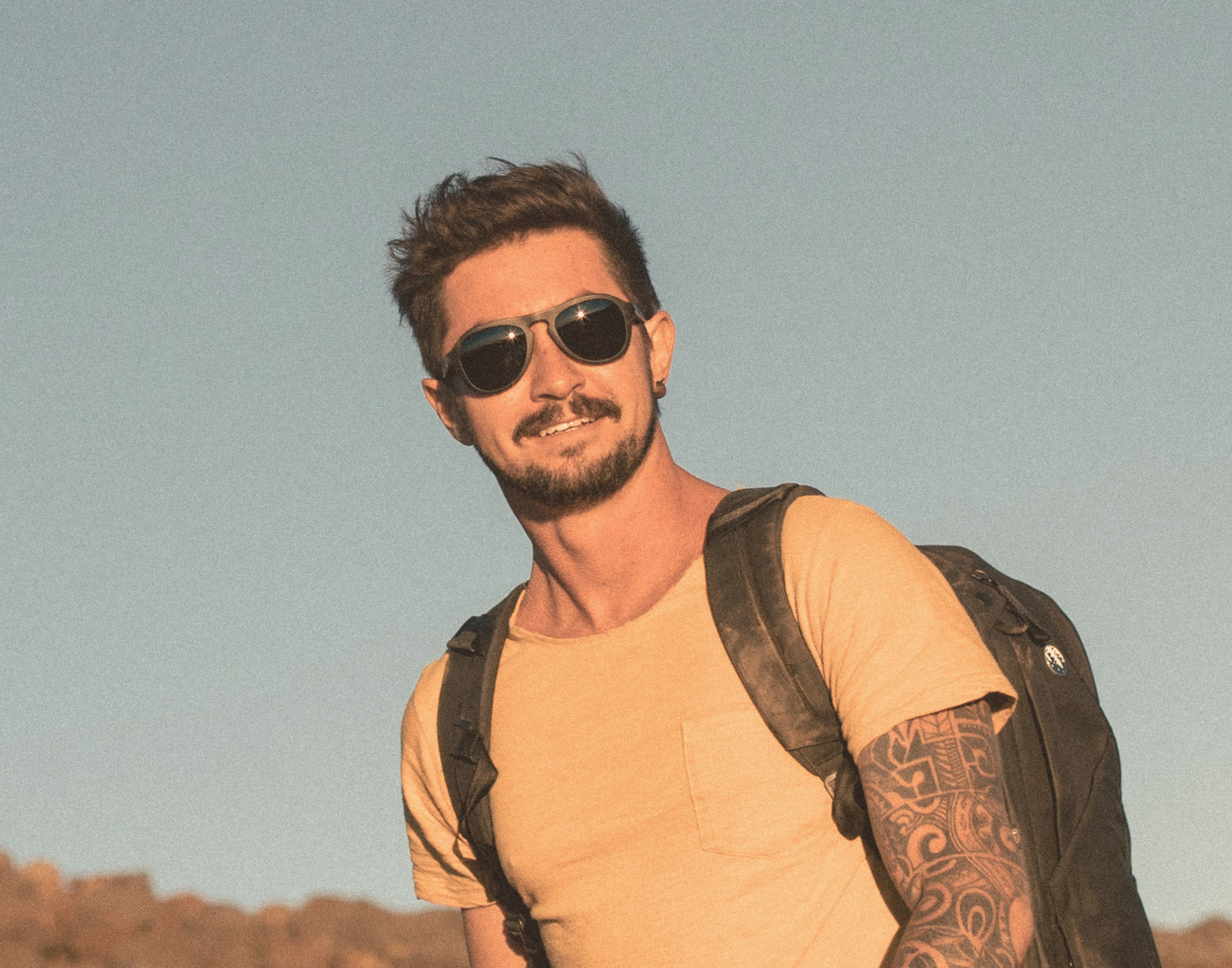 man in the sunshine wearing sunski treeline sunglasses