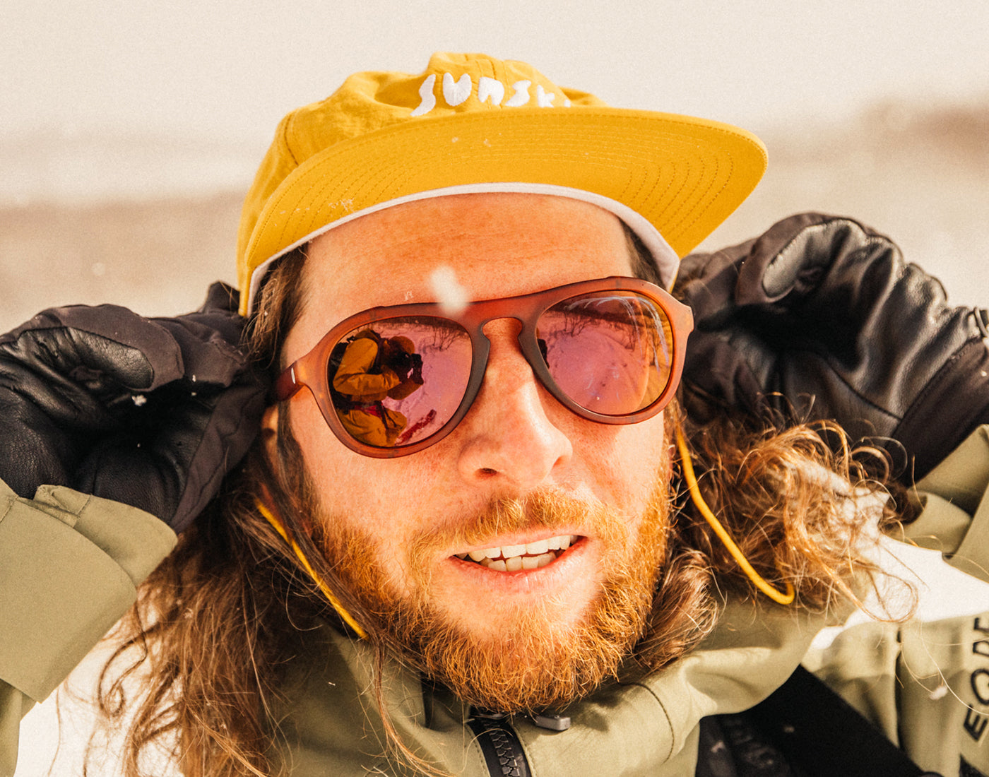 guy in a team hat wearing sunski treeline sunglasses