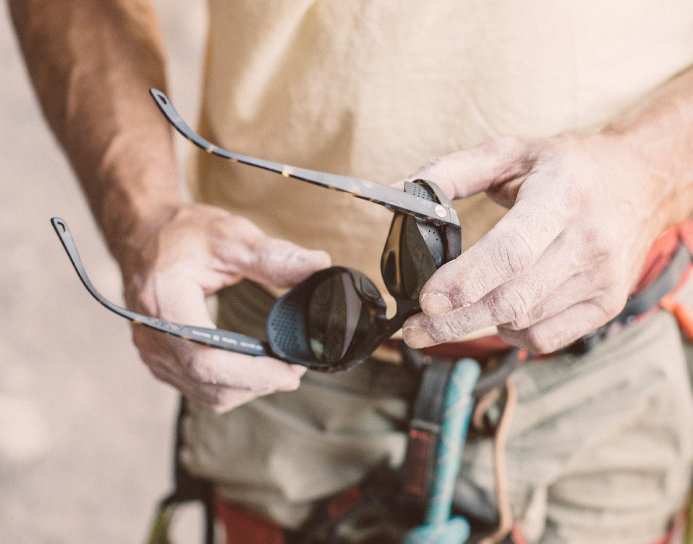 person playing with sunski treeline sunglasses