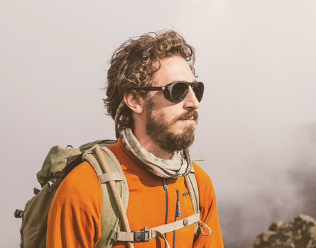 profile of a man with a hiking back wearing sunski treeline sunglasses