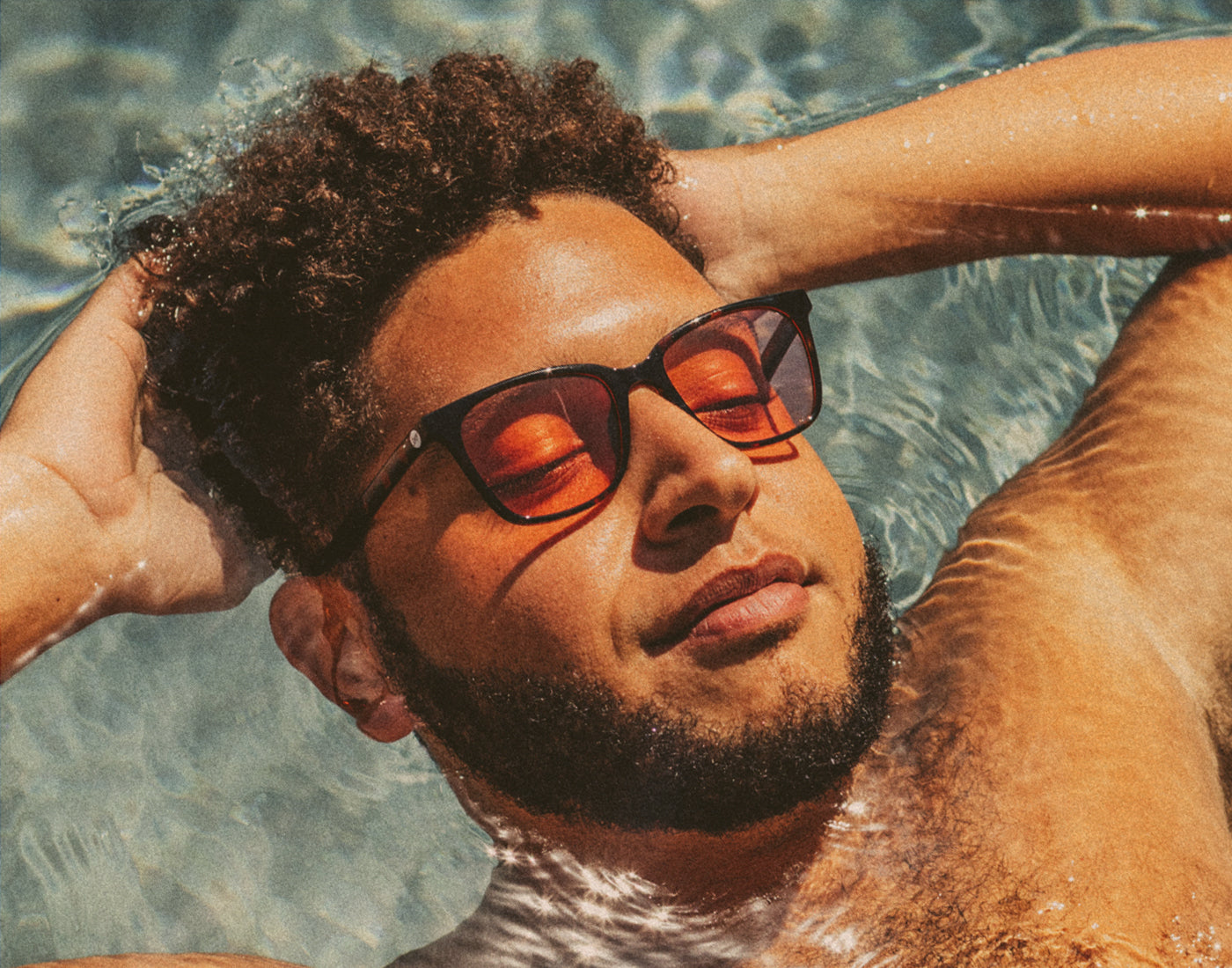 man in pool wearing sunski ventana polarized sunglasses