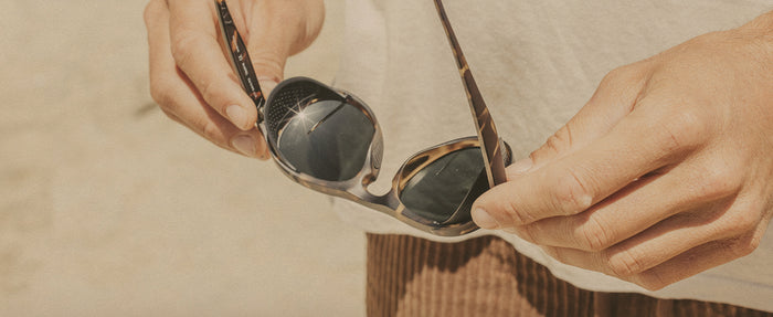 hands holding sunski treeline sunglasses