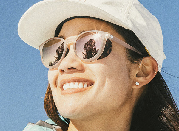 close up of girl smiling wearing sunski tera sunglasses