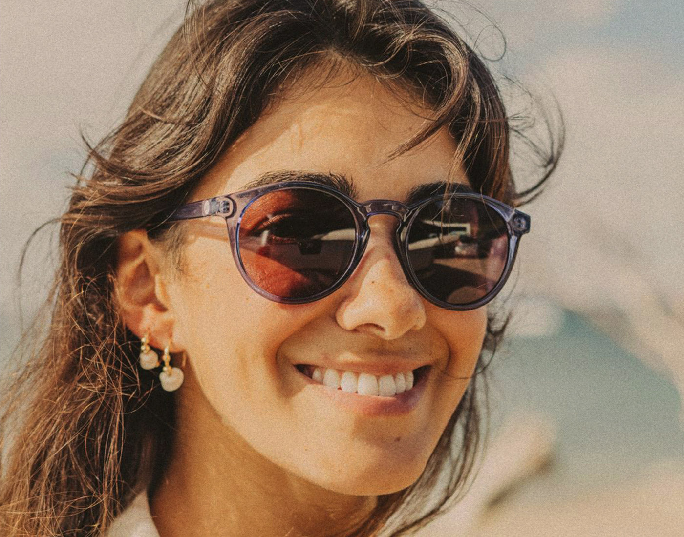 woman smiling wearing sunski dipsea sunglasses