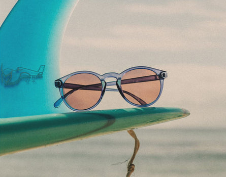 sunski dipsea sunglasses on a surf board