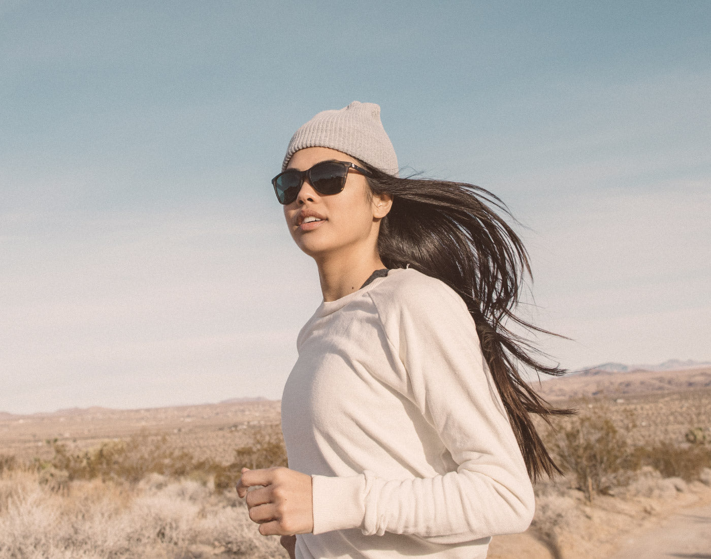 girl running wearing sunski anza sunglasses