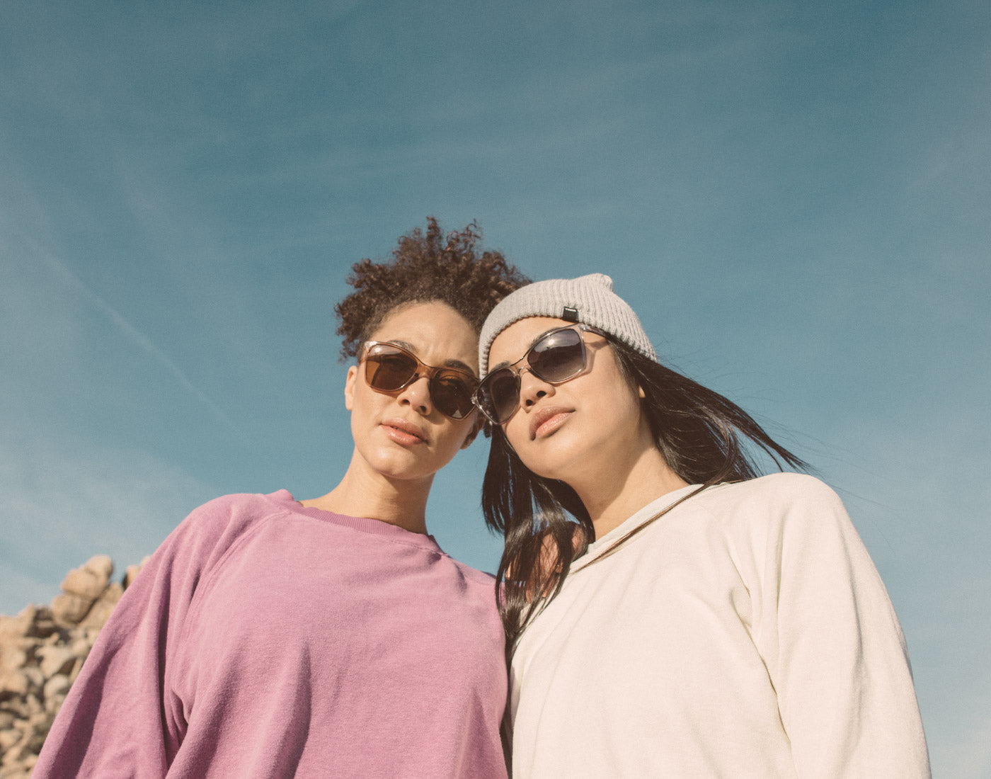 low angle shot of two girls wearing sunski anza sunglasses
