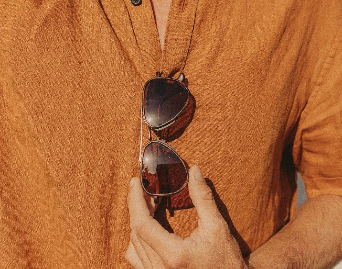 guy holding sunski astra sunglasses