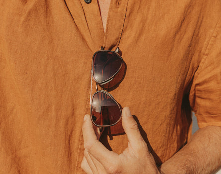 guy holding sunski astra sunglasses