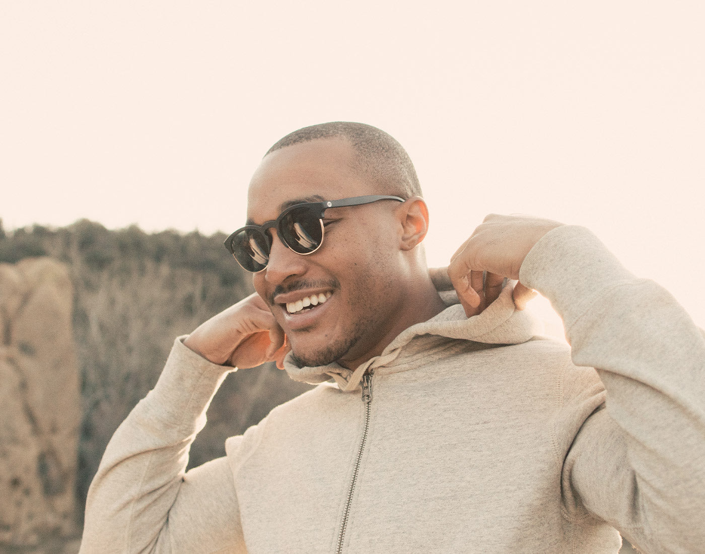 guy in hoodie wearing sunski avila sunglasses