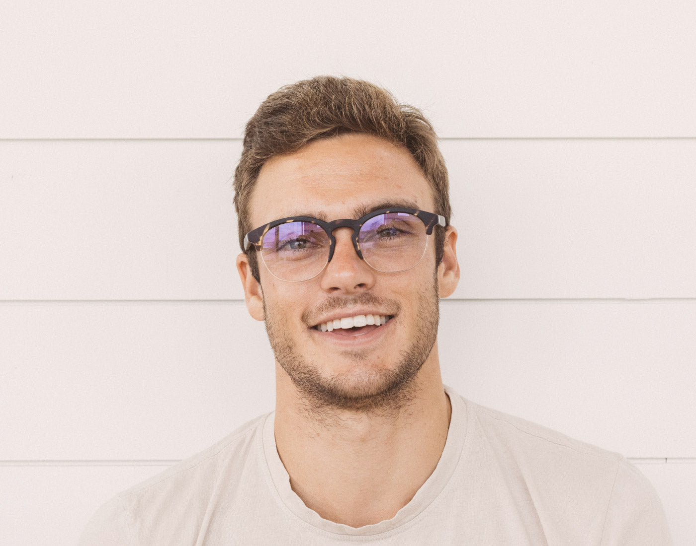 guy smiling wearing sunski avila bluelight glasses