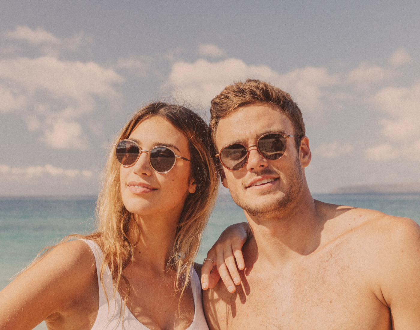 guy and girl wearing sunski baia sunglasses