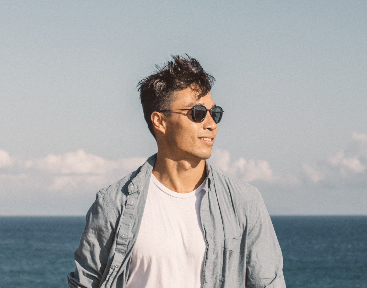 guy standing in the wind wearing sunski bernina sunglasses