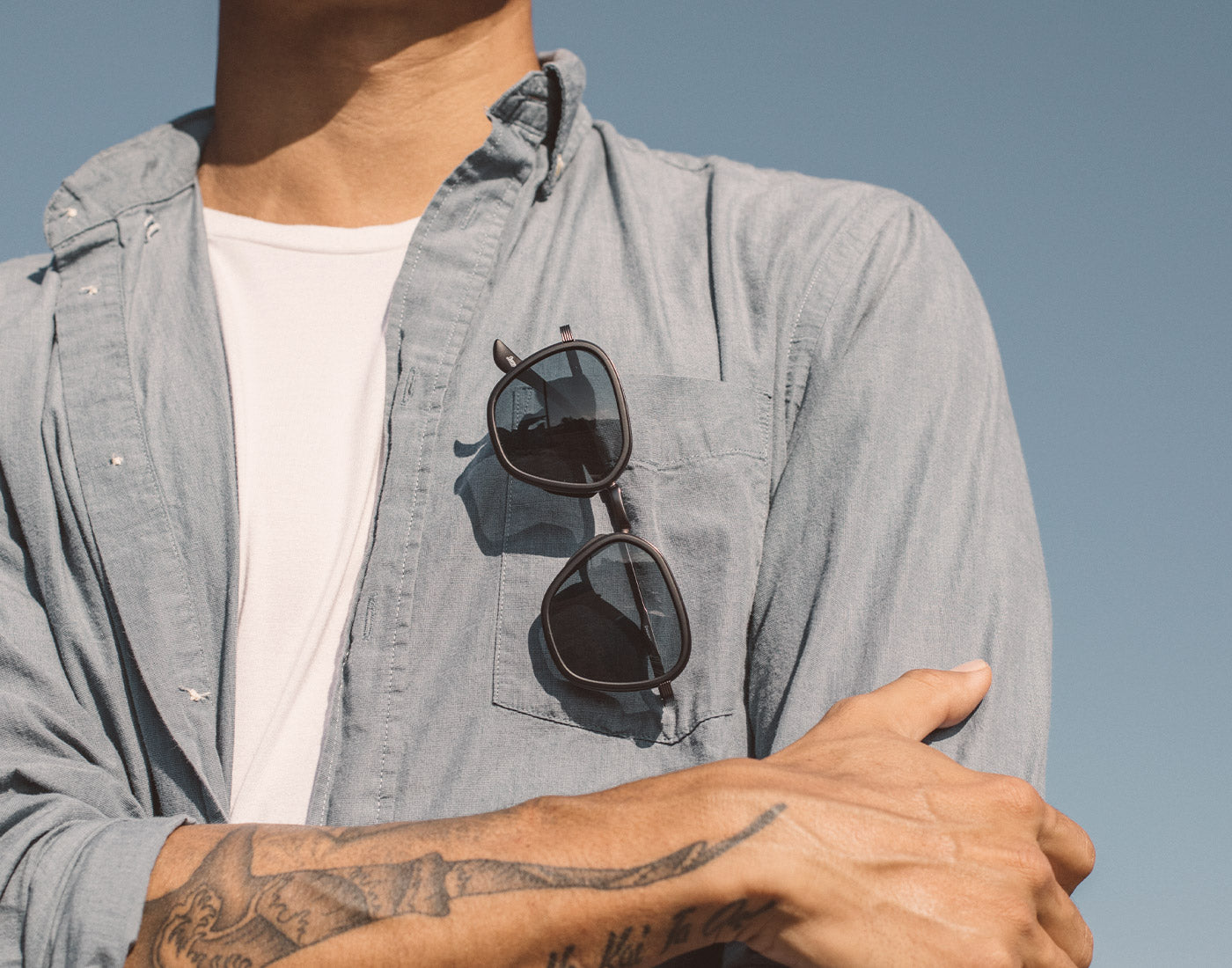 sunski bernina sunglasses hanging on a shirt pocket