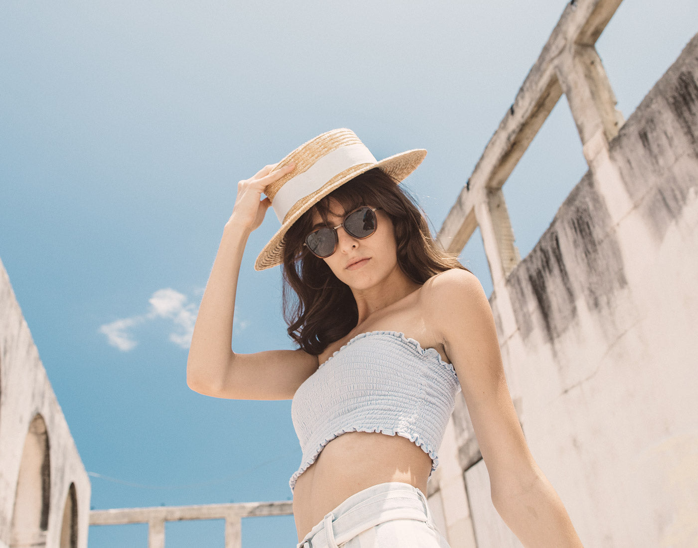 low angle shot of girl in hat wearing sunski bernina sunglasses