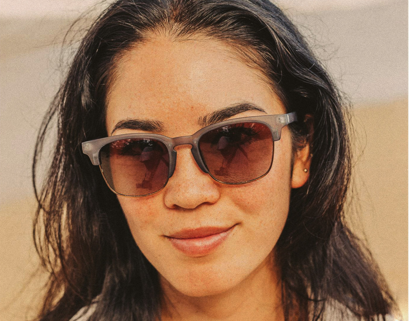 girl wearing sunski cambria navy amber sunglasses