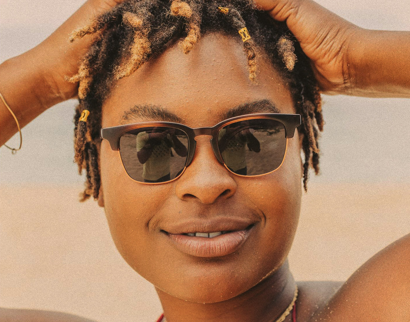 woman wearing sunski cambria whiskey tort slate sunglasses