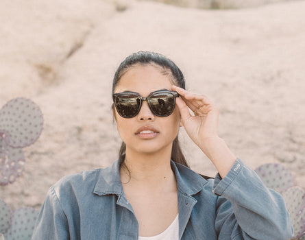 girl holding sunski camina sunglasses on face