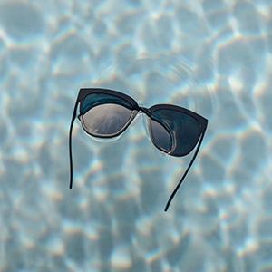 sunski camina sunglasses floating in a pool