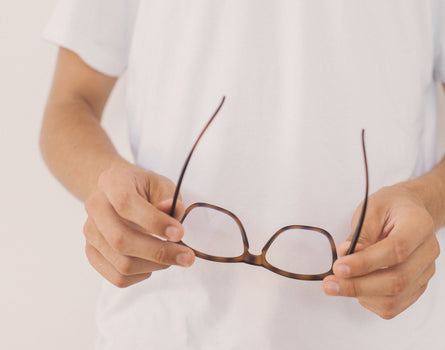 hands holding sunski classic bluelight glasses