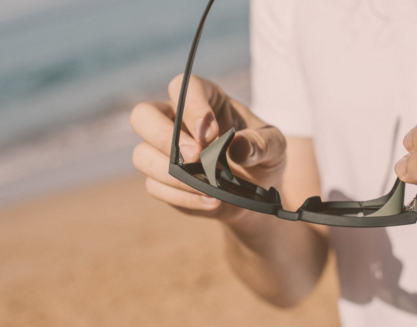 hands messing with side shield on sunski couloir sunglasses