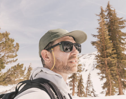 profile of guy in the snowy wearing sunski couloir sunglasses