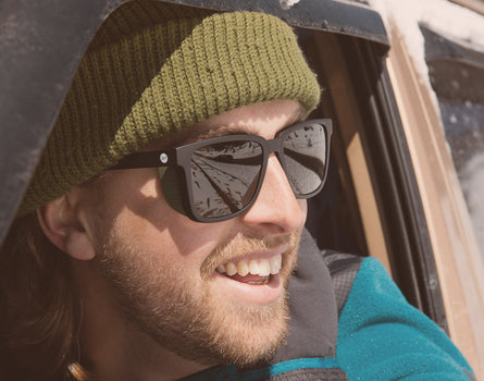 close up of guy out car window wearing sunski couloir sunglasses