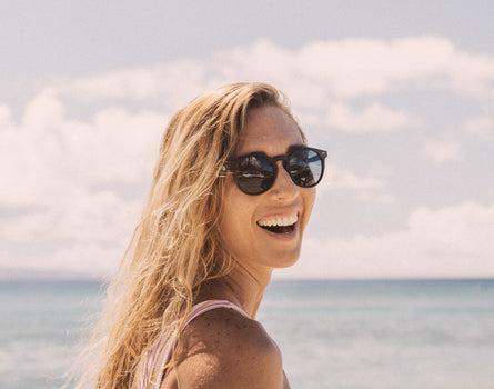 girl looking over shoulder laughing wearing sunski dipsea sunglasses