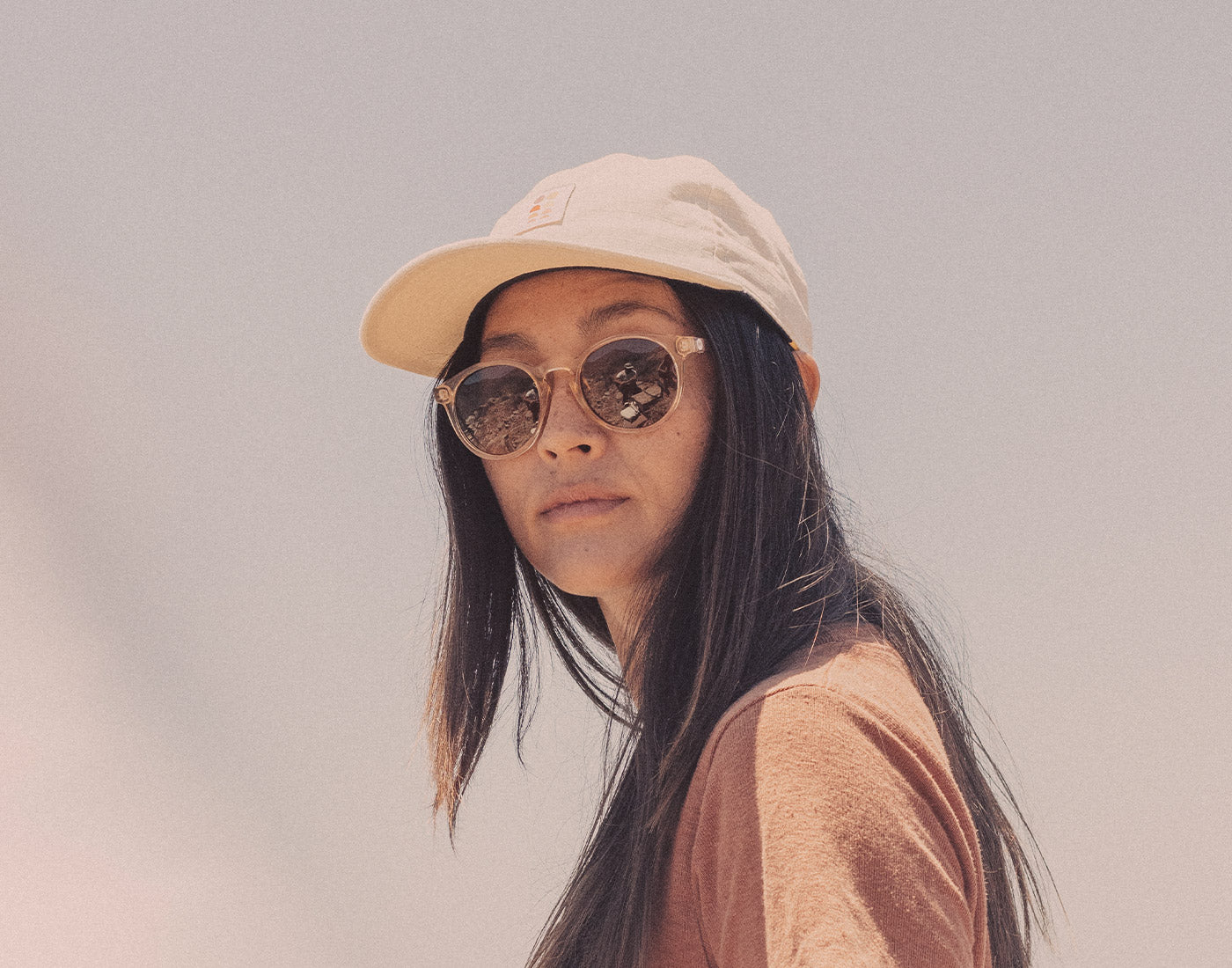 girl wearing hat in sunski dipsea sunglasses