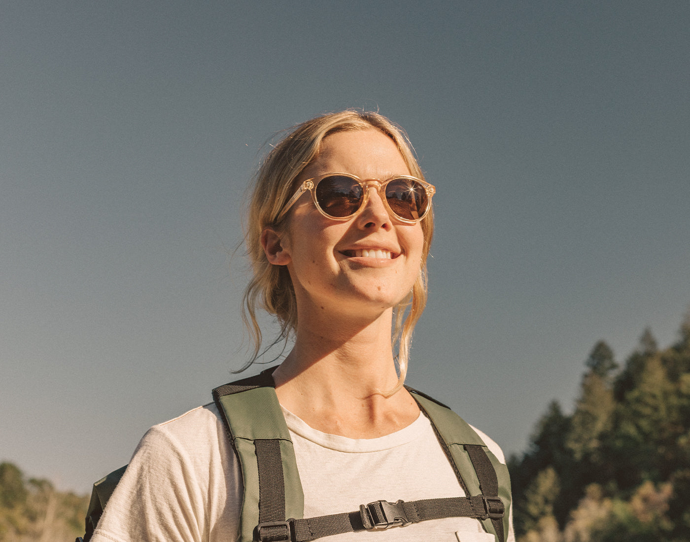  girl backpacking wearing sunski dipsea sunglasses