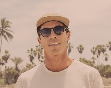 guy in a hat wearing sunski dipsea sunglasses